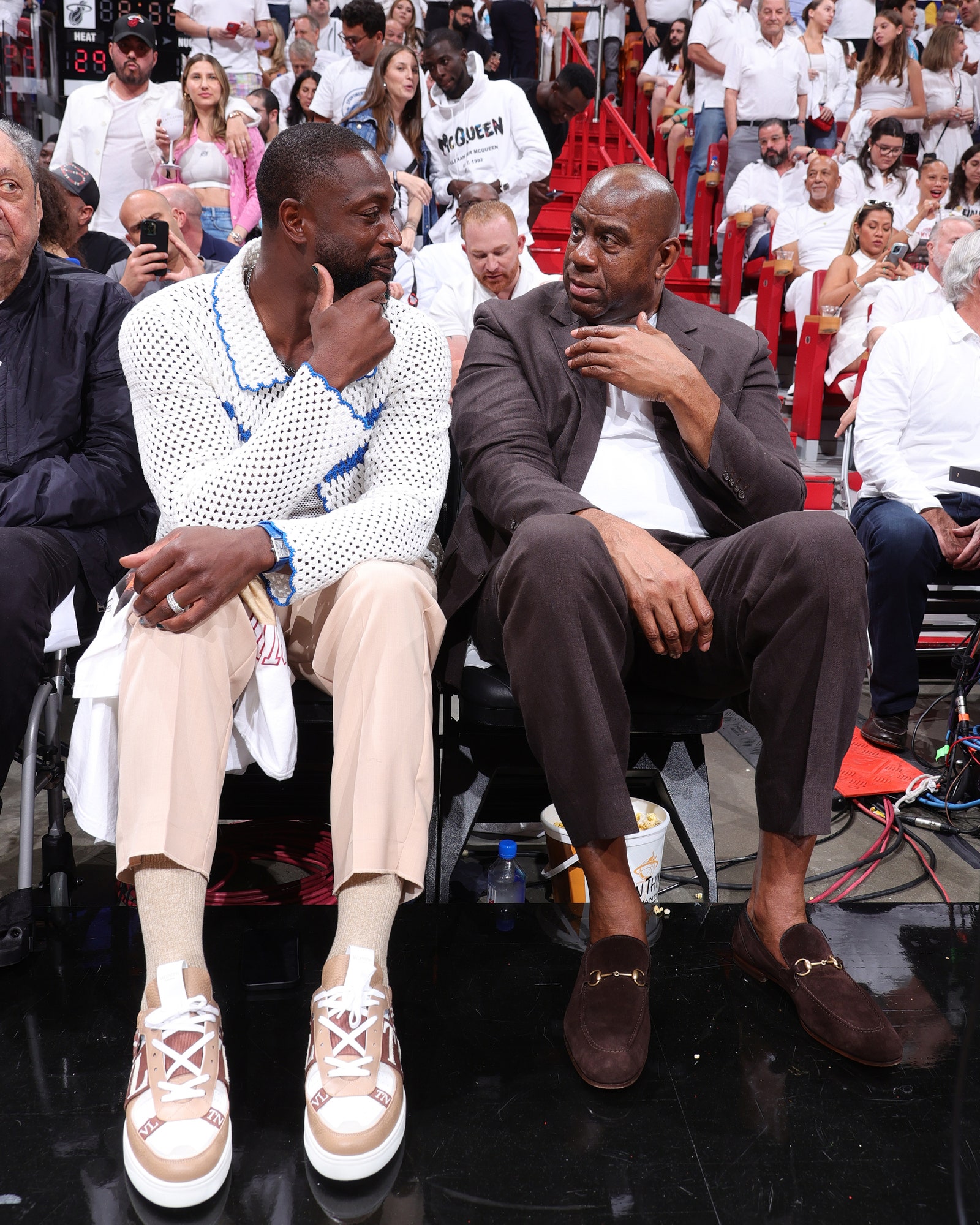 MIAMI FL  JUNE 7 Dwyane Wade and Magic Johnson attend Game Three of the 2023 NBA Finals between the Denver Nuggets and...